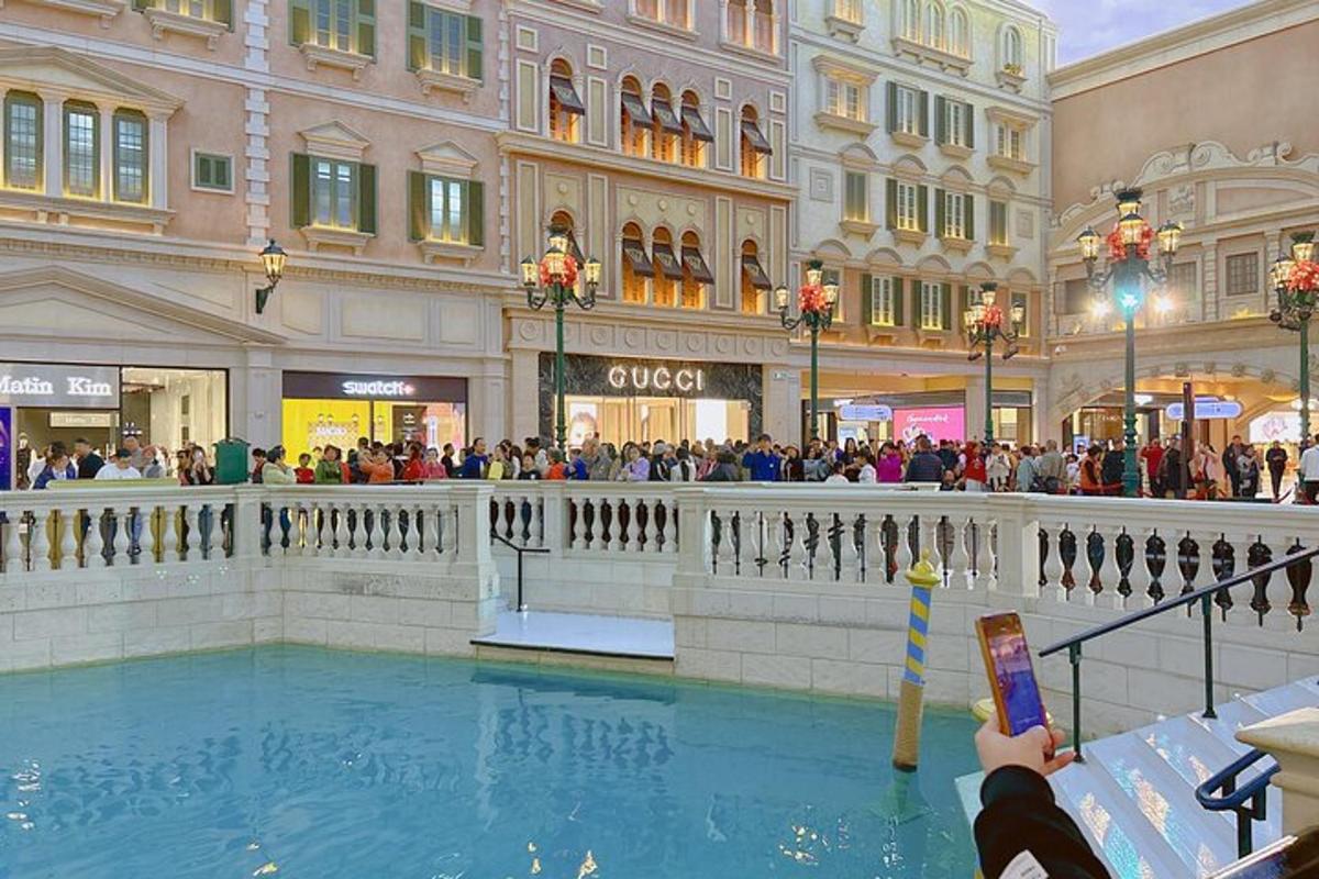 a person taking a picture of a pool in a shopping mall