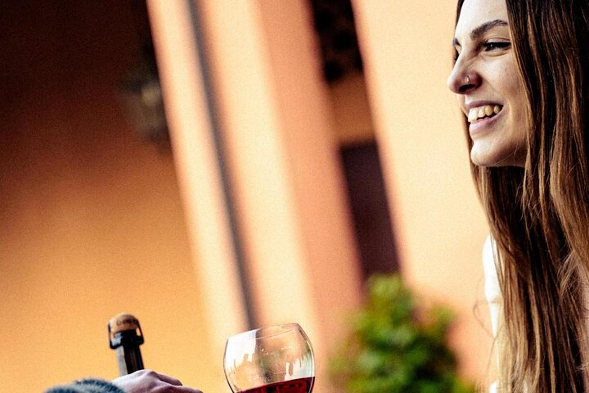o femeie care ține un pahar de vin roșu