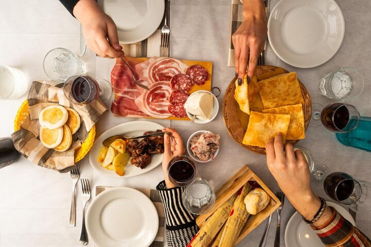 a group of people sitting at a table with food