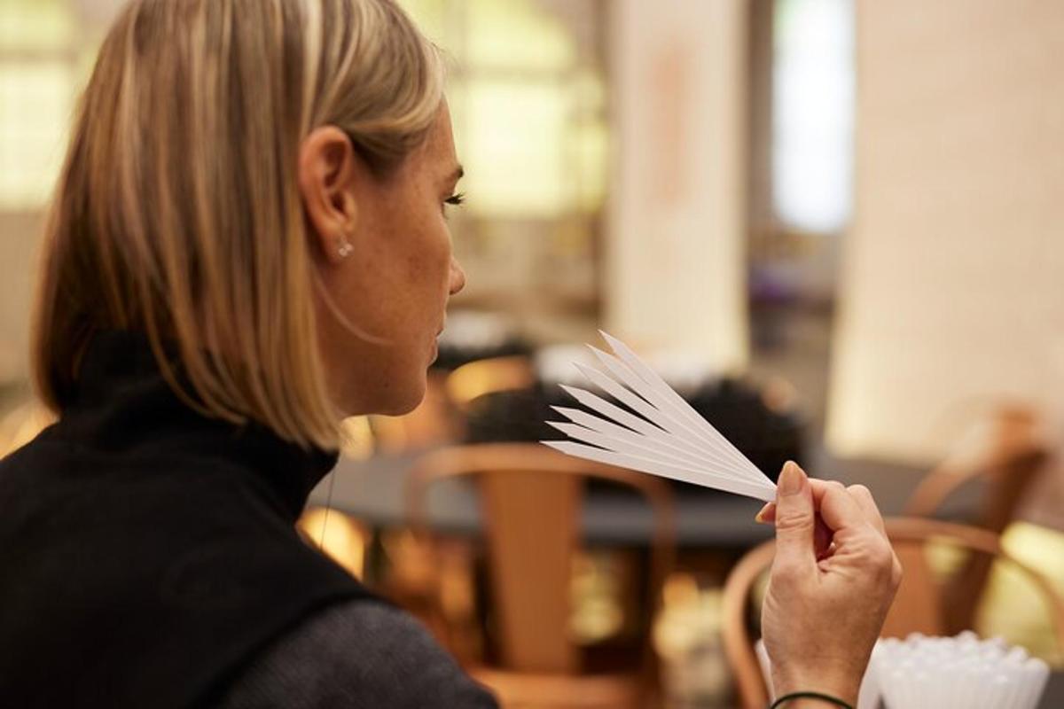 a woman is holding up a stack of paperaments