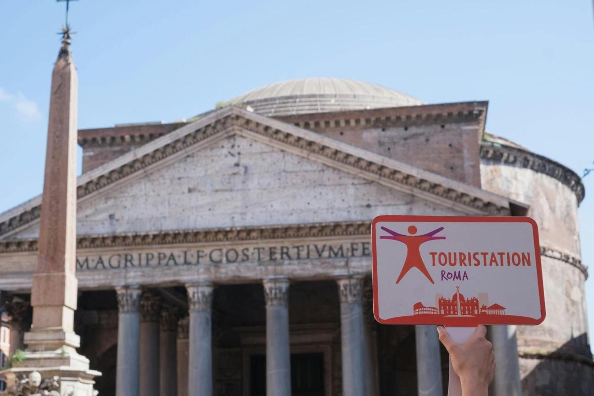 a person holding a sign in front of a building