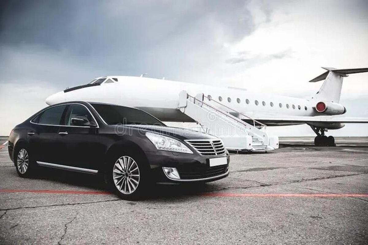a black car parked next to a white airplane