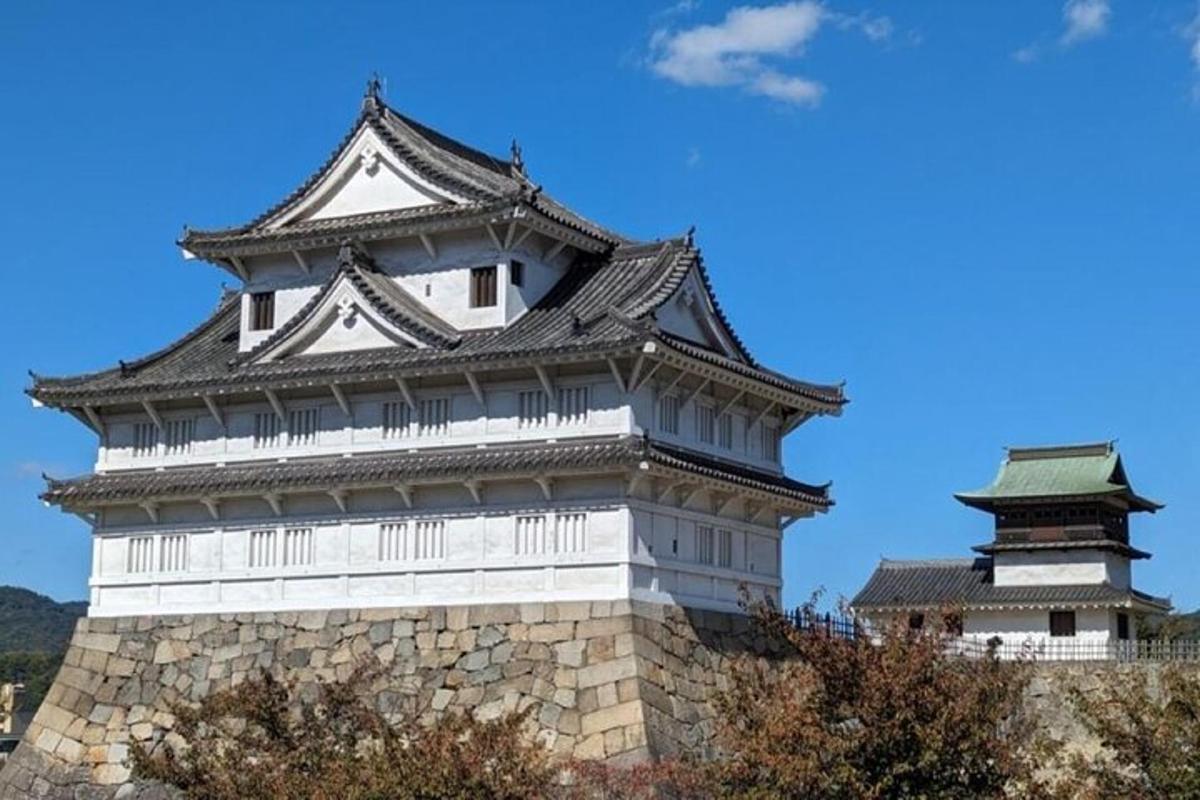 a tall building with two towers on top of a wall