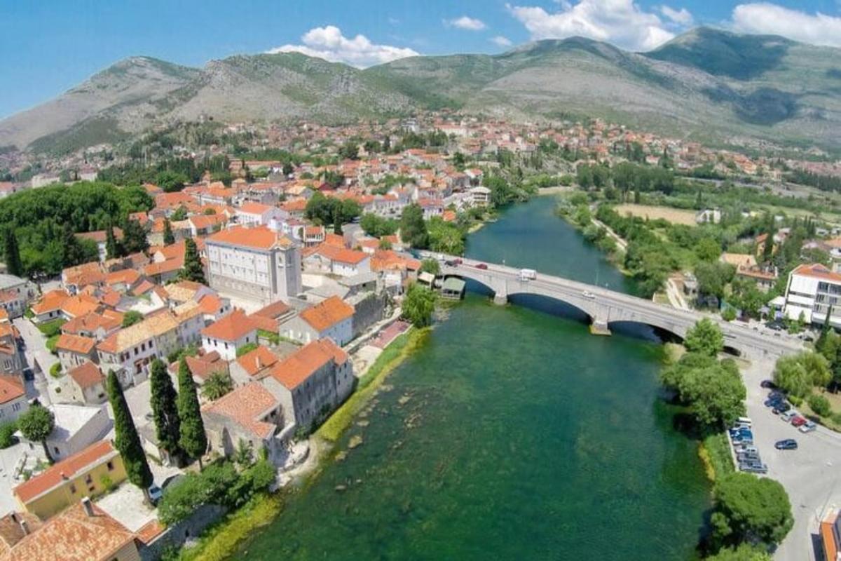 an aerial view of a town with a bridge over a river
