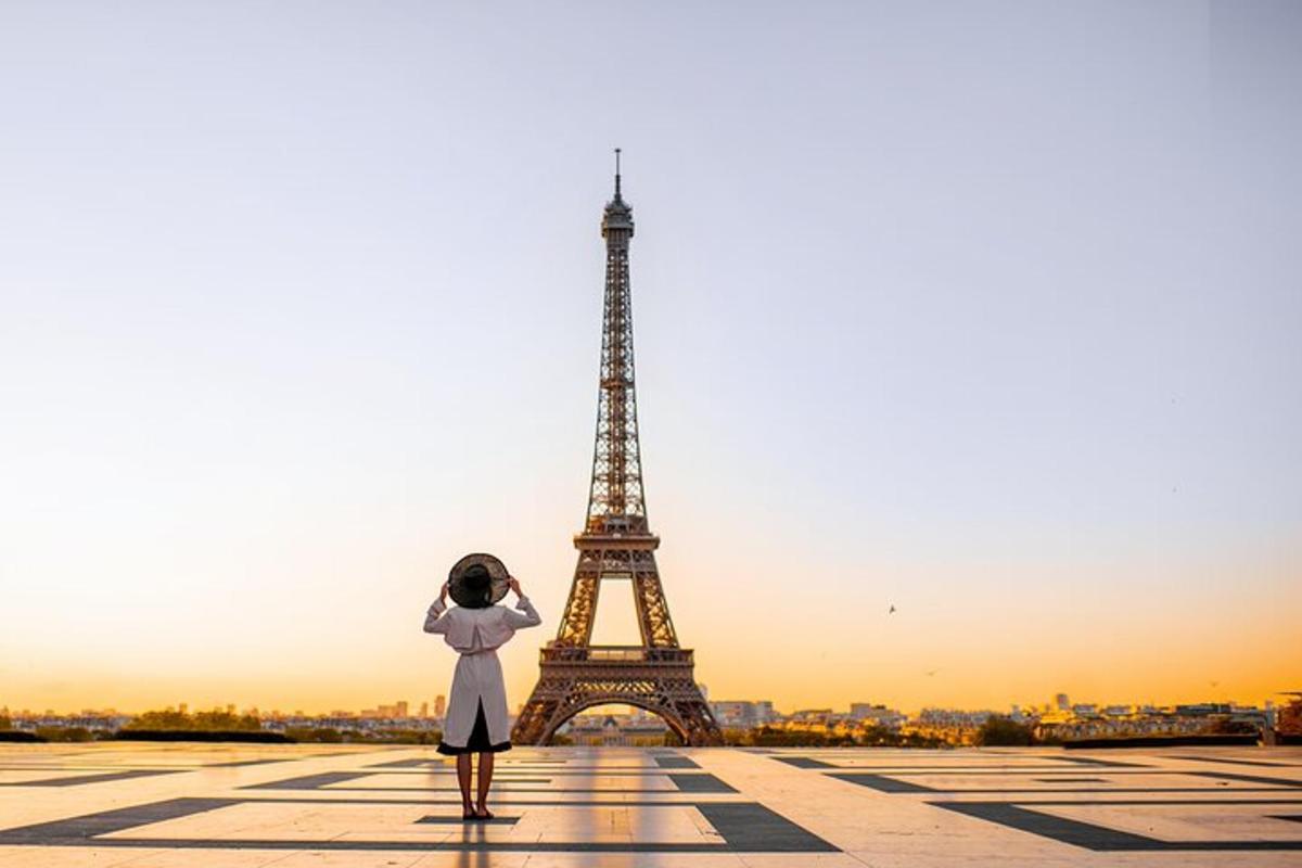 a woman standing in front of the eiffel tower