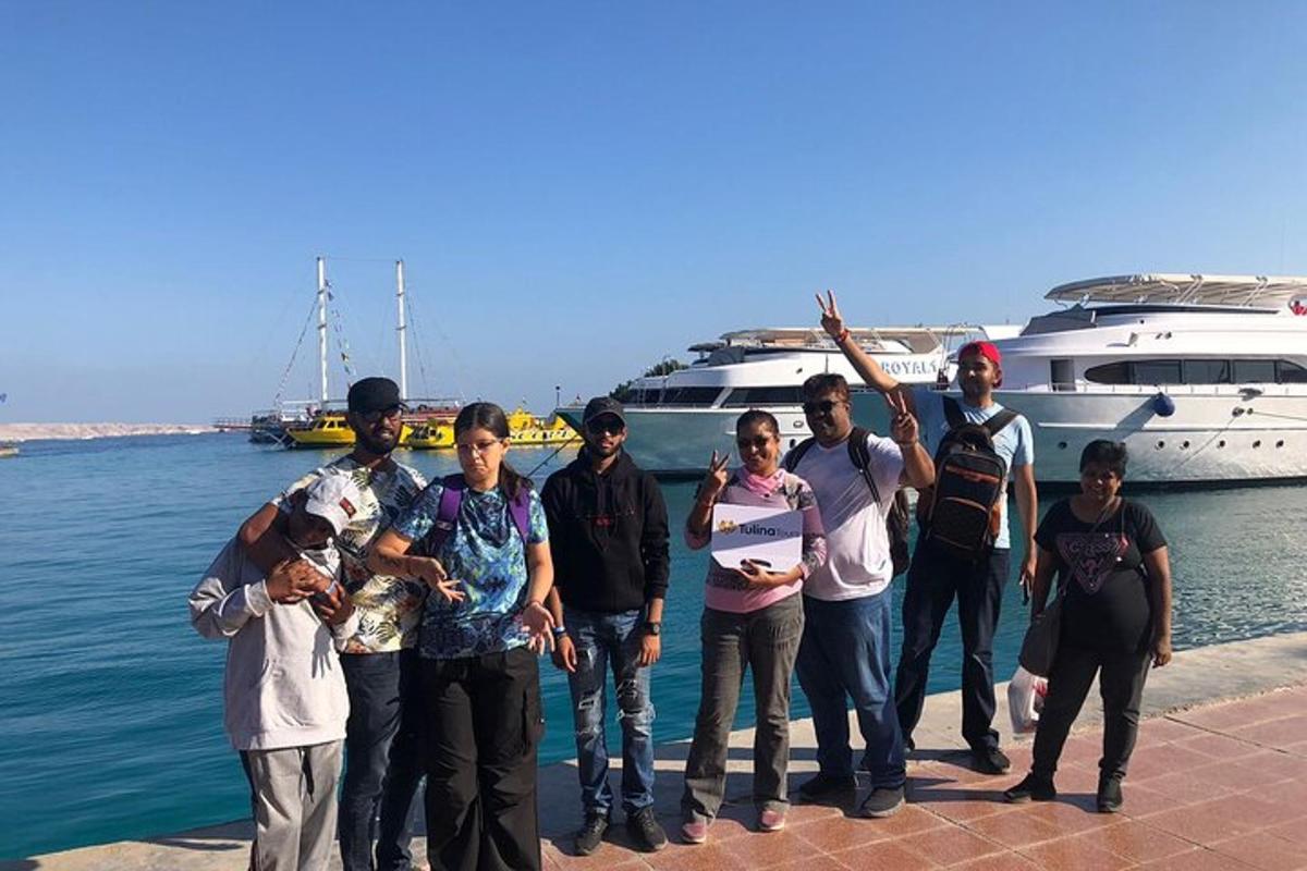 a group of people standing in front of a boat
