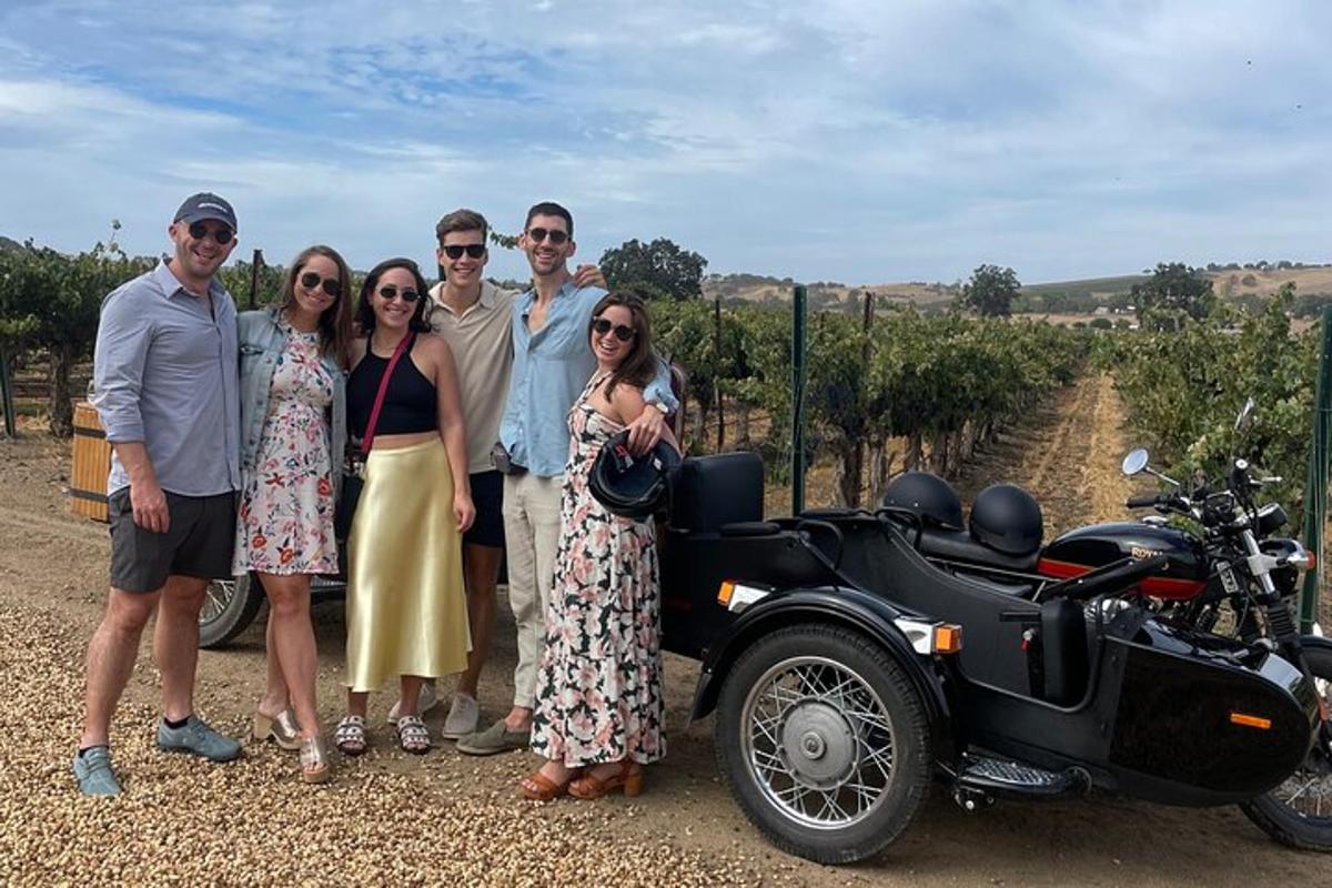 a group of people standing next to a motorcycle