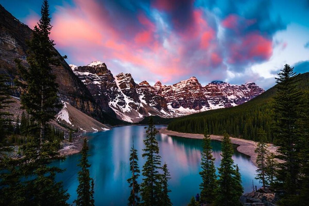 a lake in the middle of a mountain range with snow