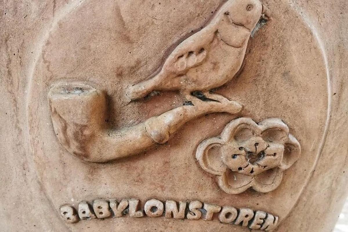 a stone statue of a bird and a flower