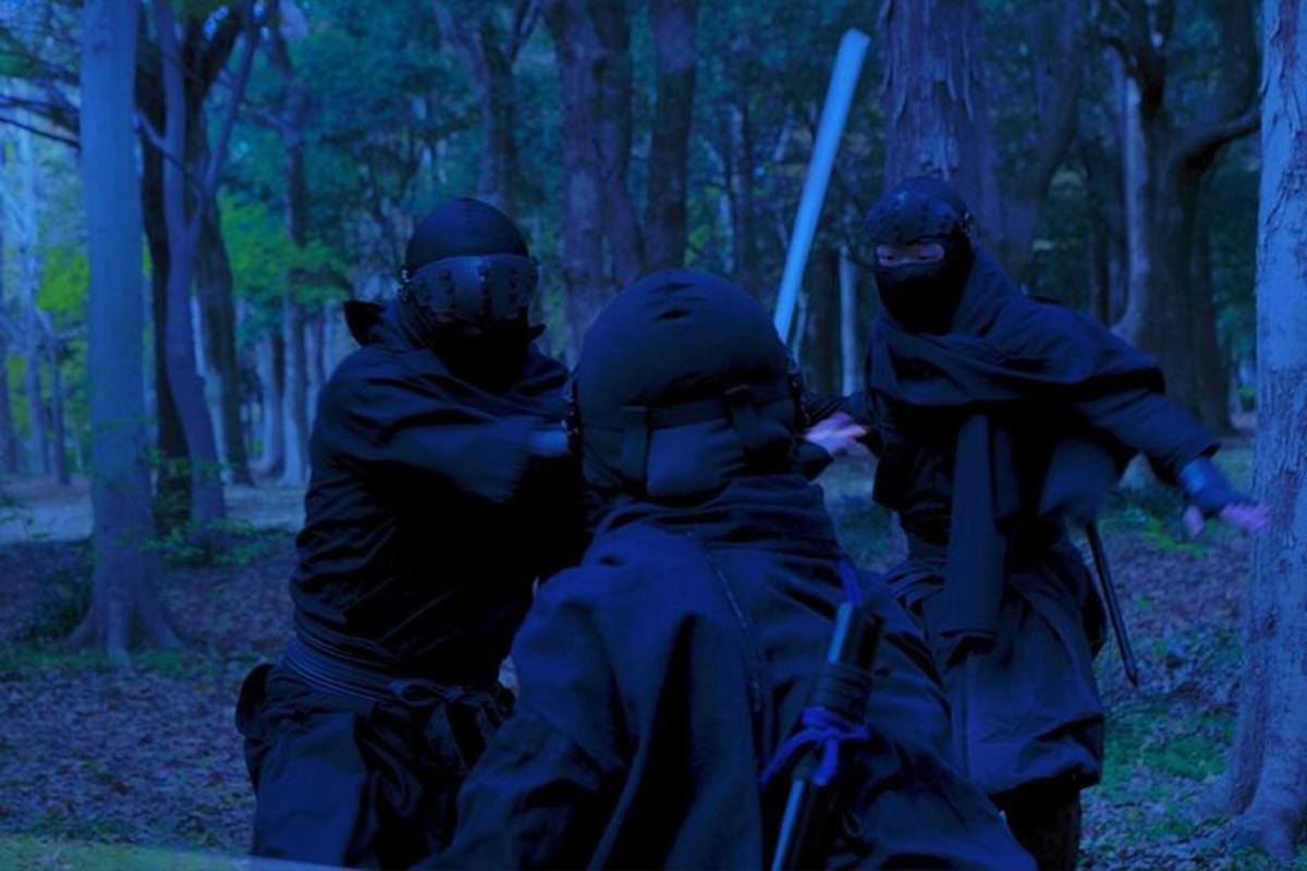 a group of three soldiers in the woods with guns