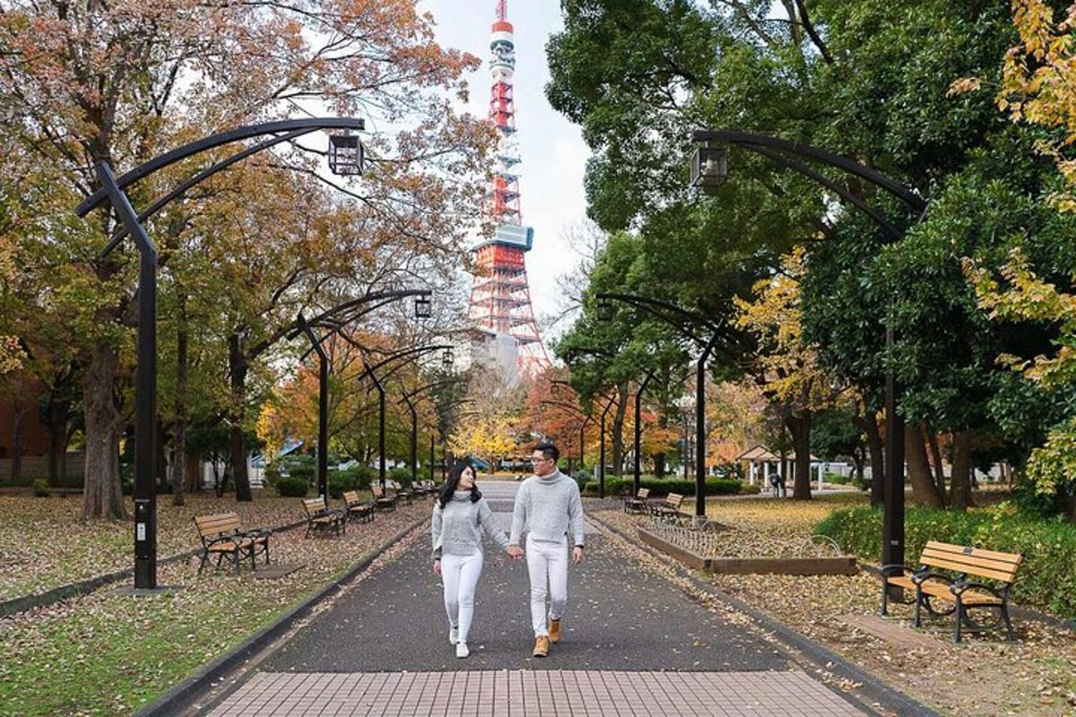 a man and woman walking down a path in a park
