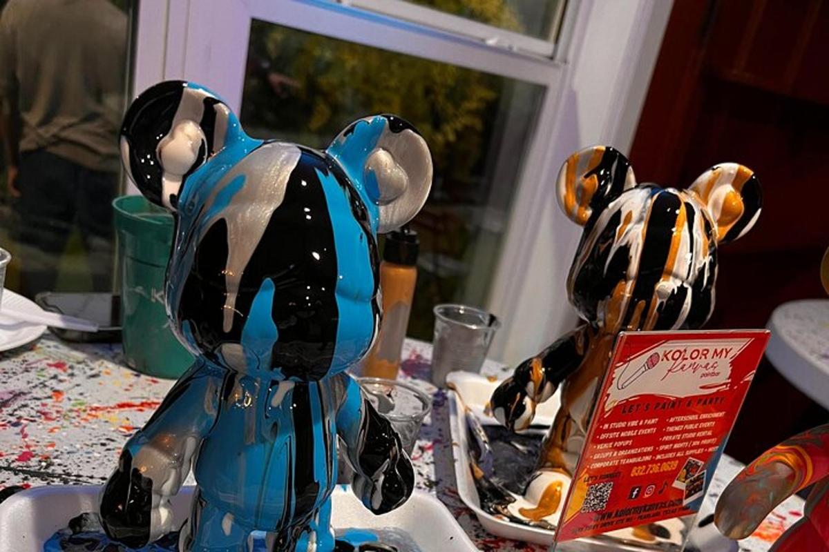 two figurines of dogs sitting on a table