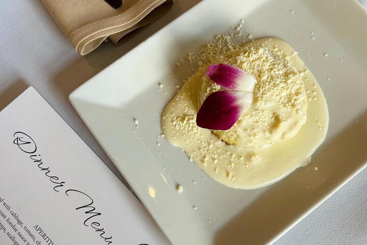 a white plate with a dessert with a flower on it