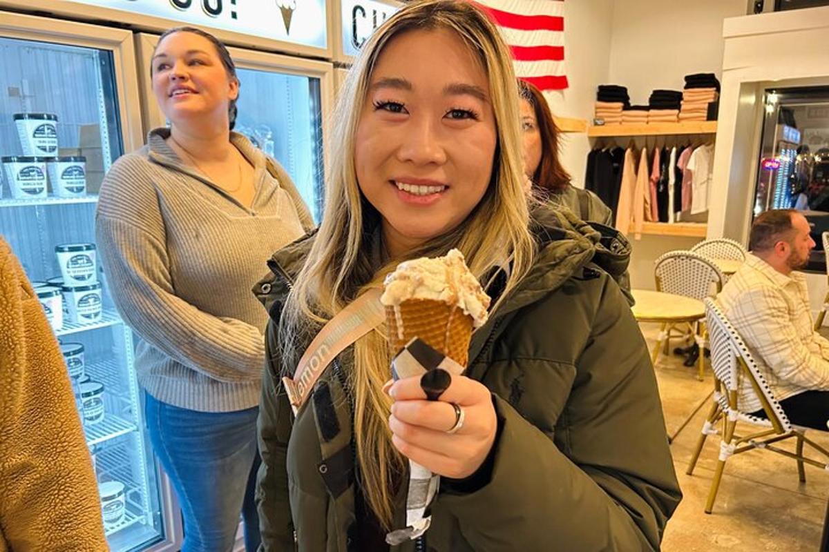 a woman holding an ice cream cone in a store
