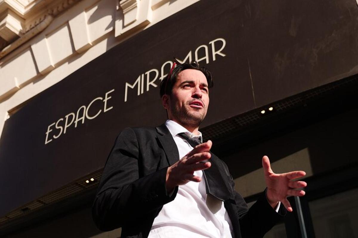 a man in a suit and tie giving a thumbs up
