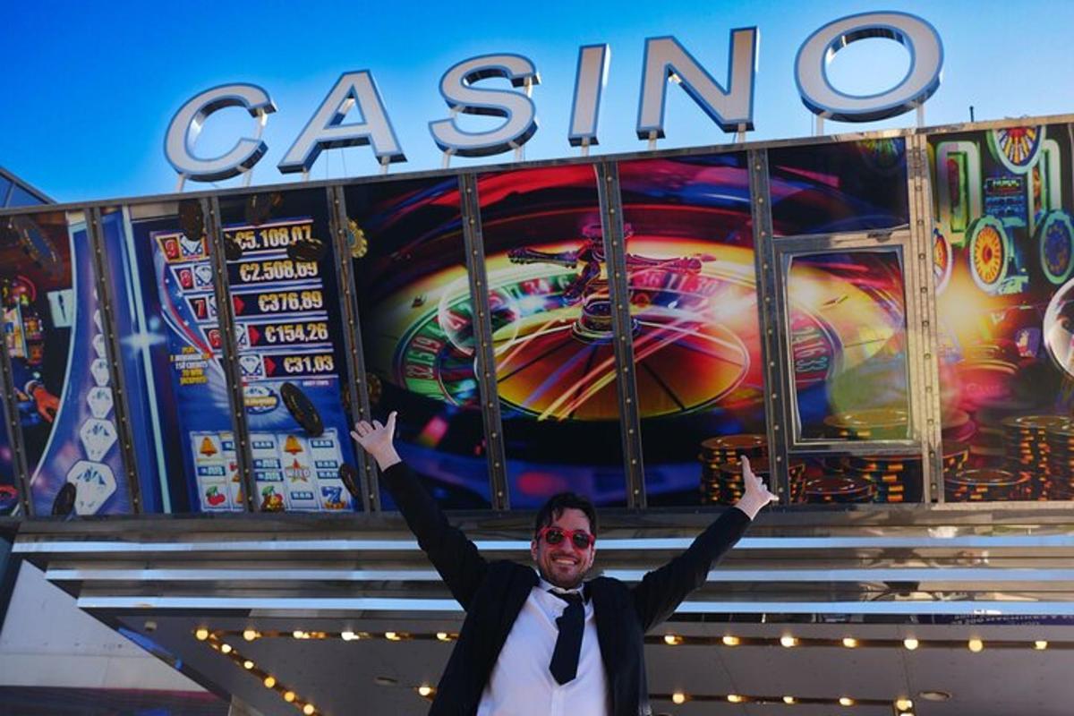 a man in a suit and tie standing in front of a casino