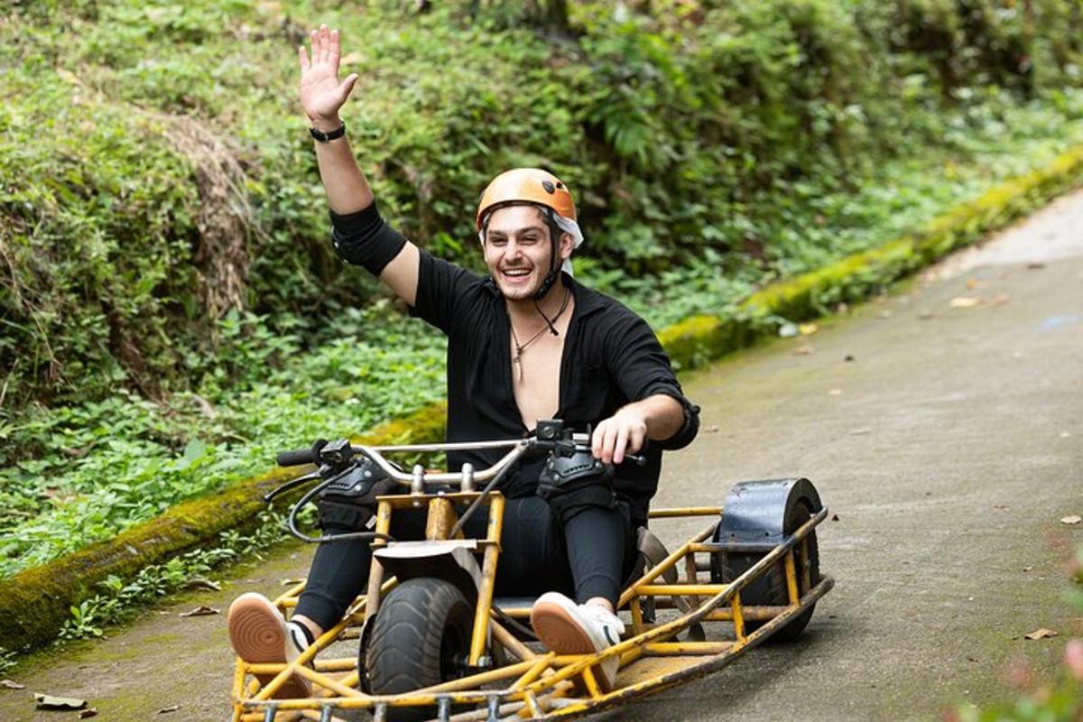 a man riding a quad bike with his hand in the air