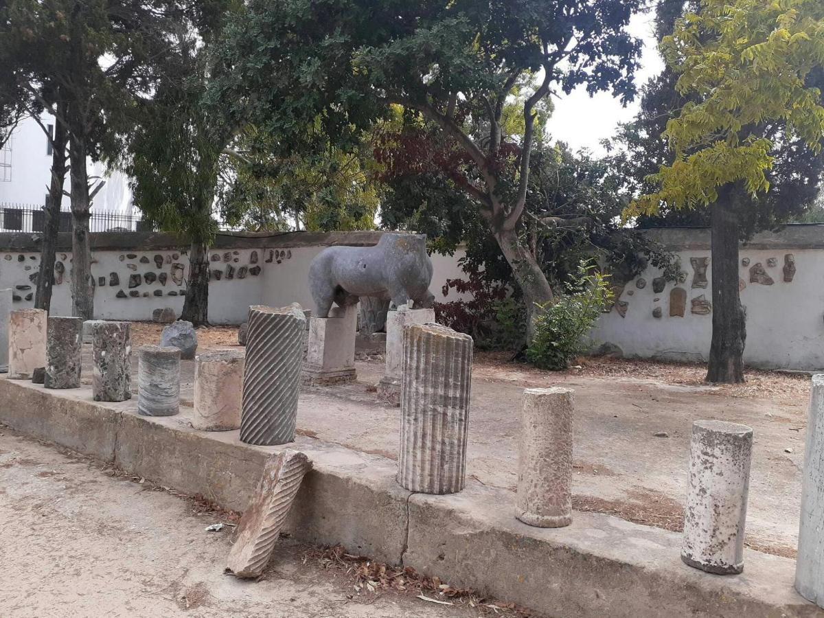 a statue of an elephant in front of a wall