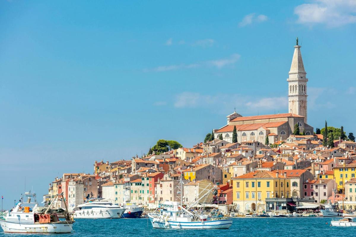 a town on a hill with boats in the water