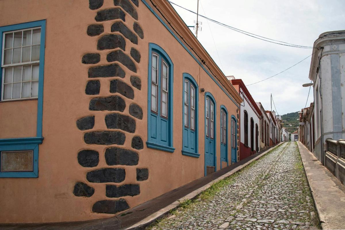 an alley with blue windows on a building