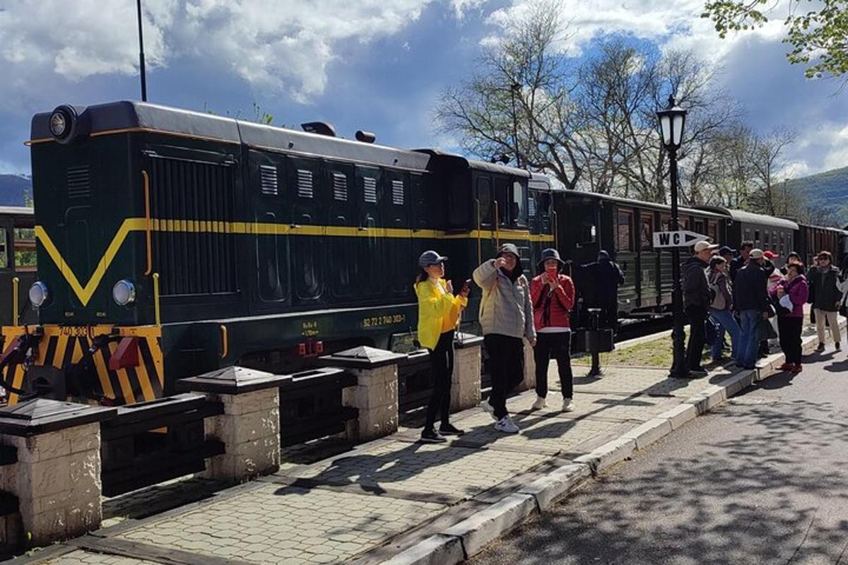 a group of people standing next to a train