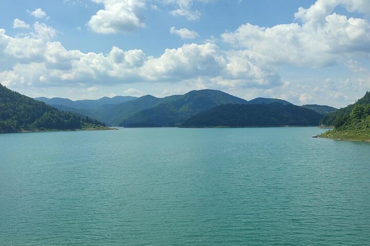 a large body of water with mountains in the background