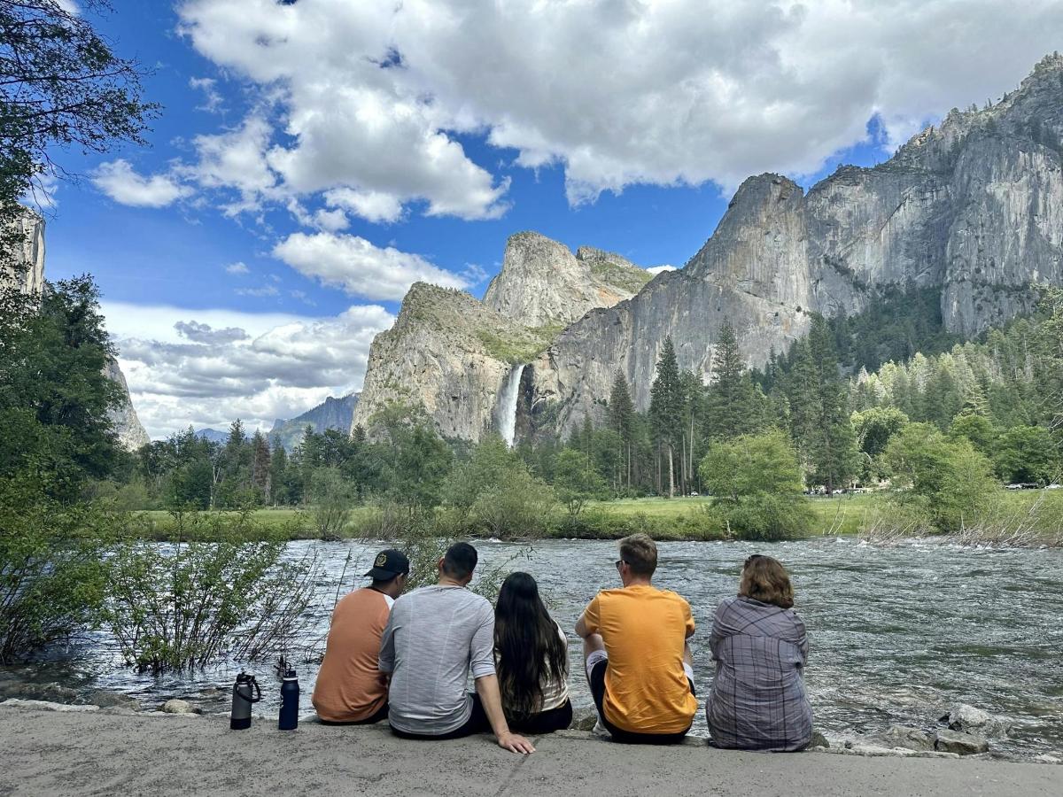 a group of people sitting in front of a river