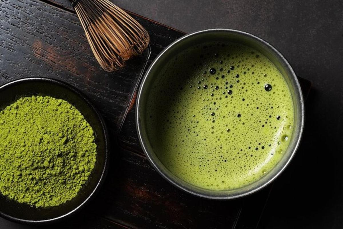 two metal pans filled with green liquid on a table