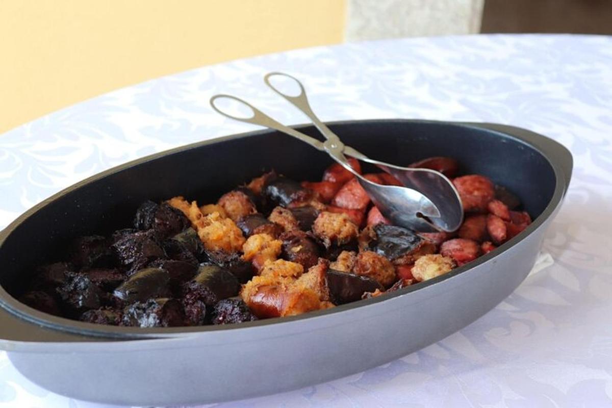 a pan of food sitting on a table with spoons