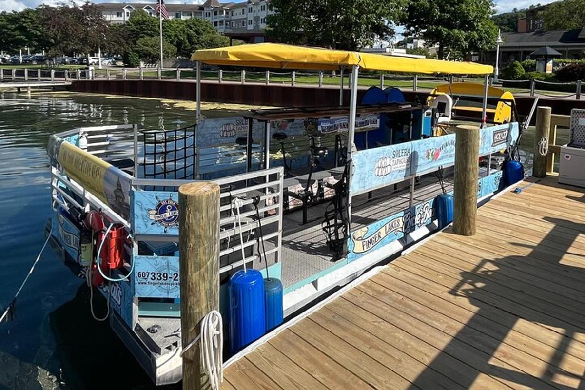 a boat tied up to a dock with an umbrella