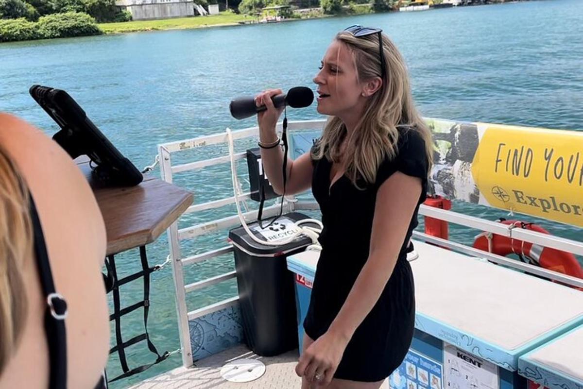 a woman singing into a microphone on a boat