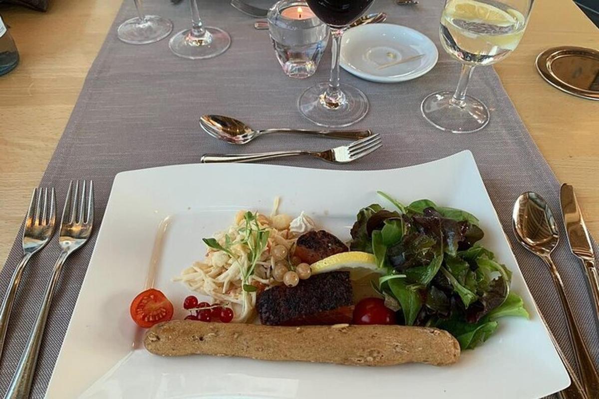a plate of food with salad and meat on a table