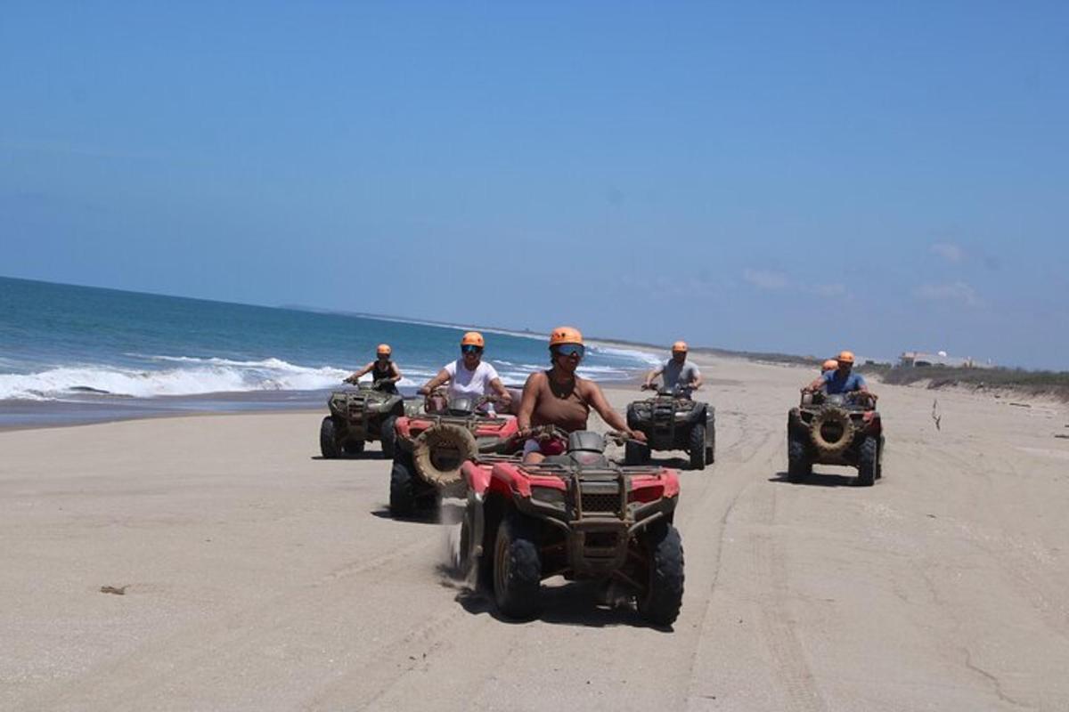 isang grupo ng mga taong nakasakay sa mga atv sa dalampasigan