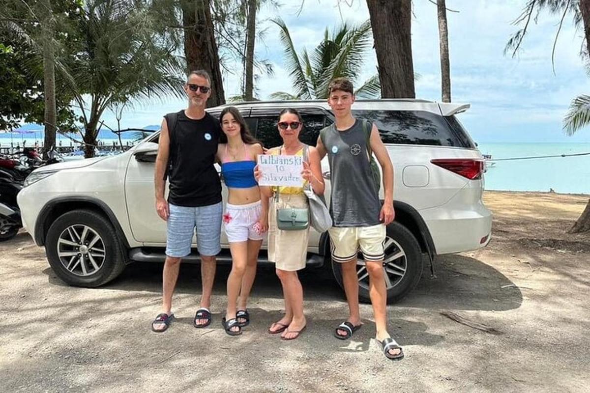 a group of people standing in front of a car