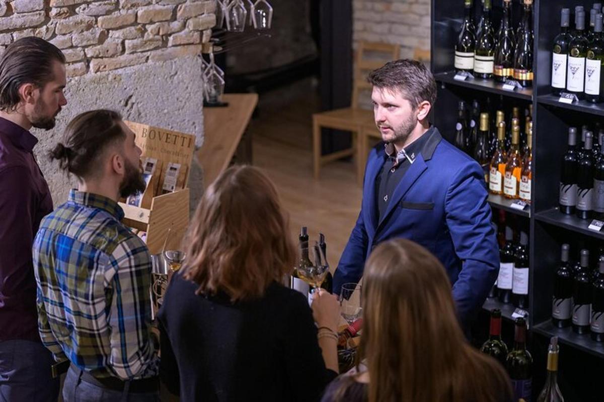 човек у оделу стоји у бару са групом људи
