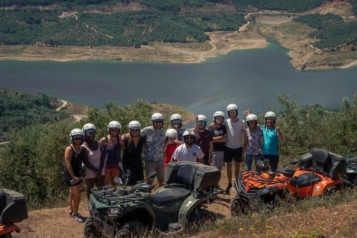 a group of people standing on a hill next to motorcycles
