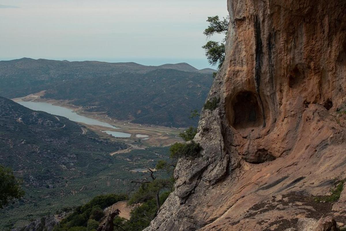 a rock cliff with a view of a river