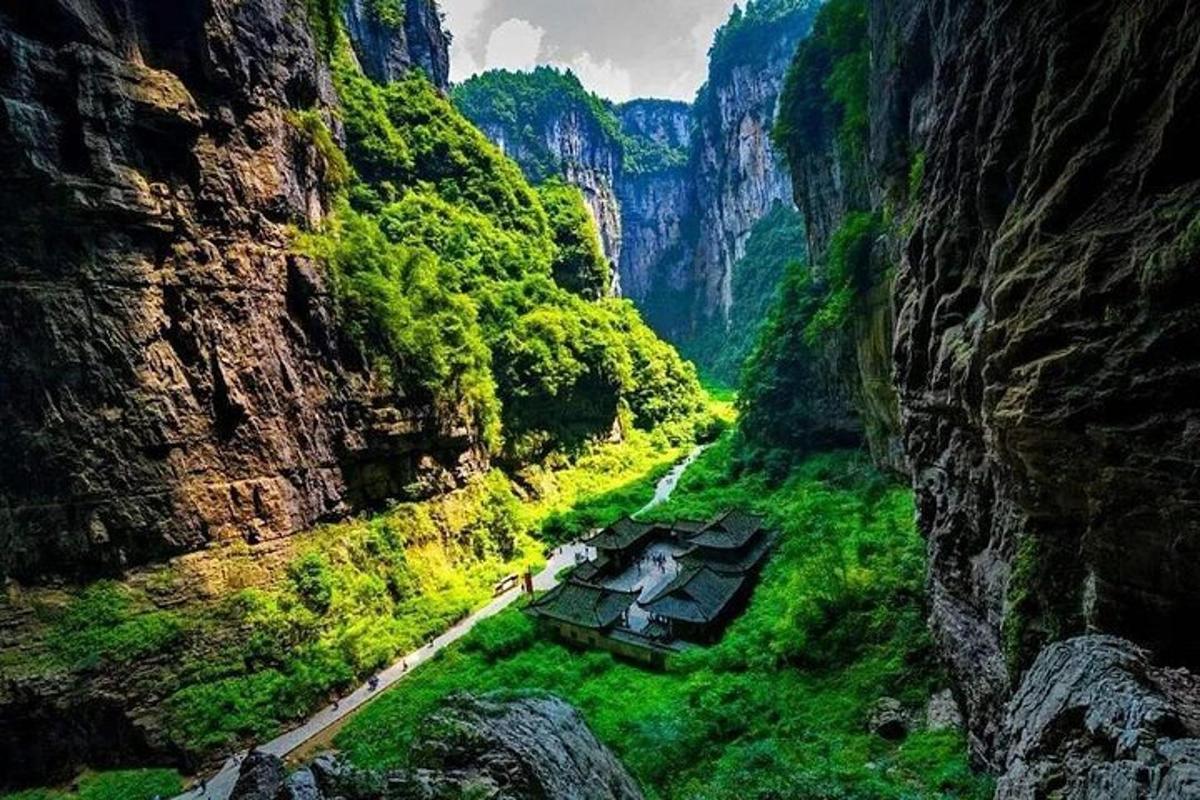 a view of a canyon with green grass and trees