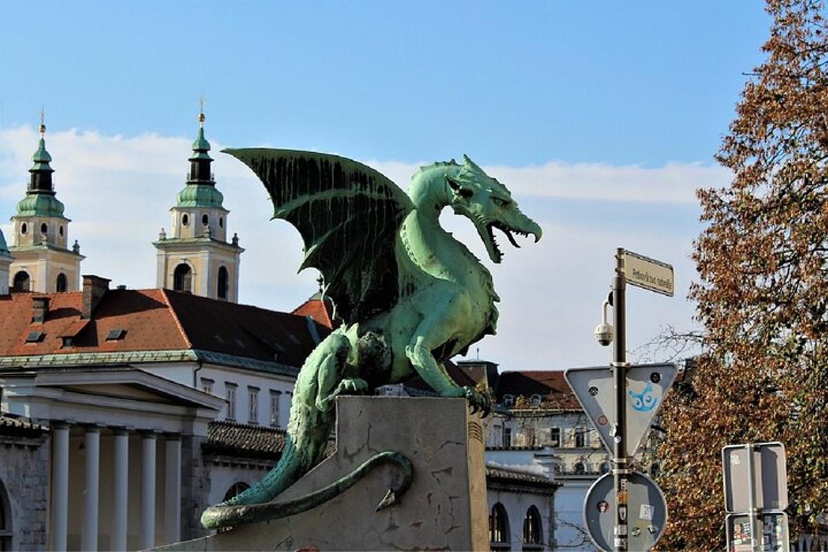 a statue of a green dragon in front of a building