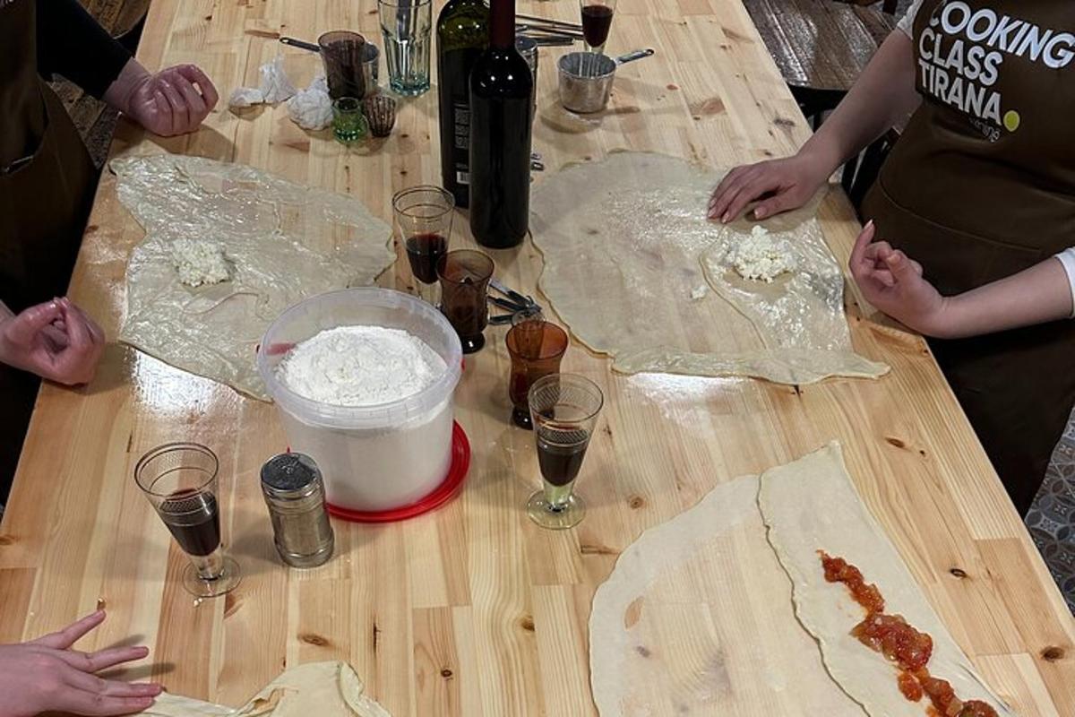 um grupo de pessoas preparando comida em uma mesa de madeira