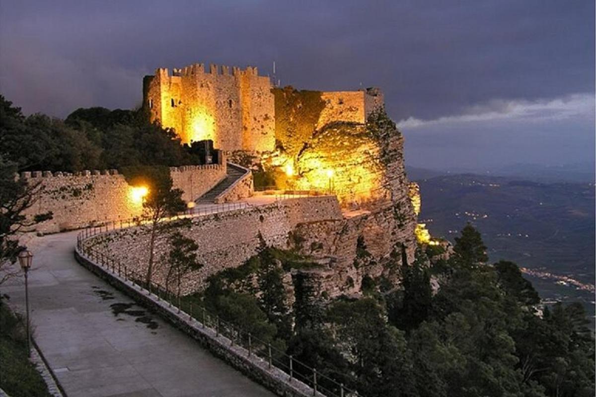 a castle sitting on top of a mountain at night