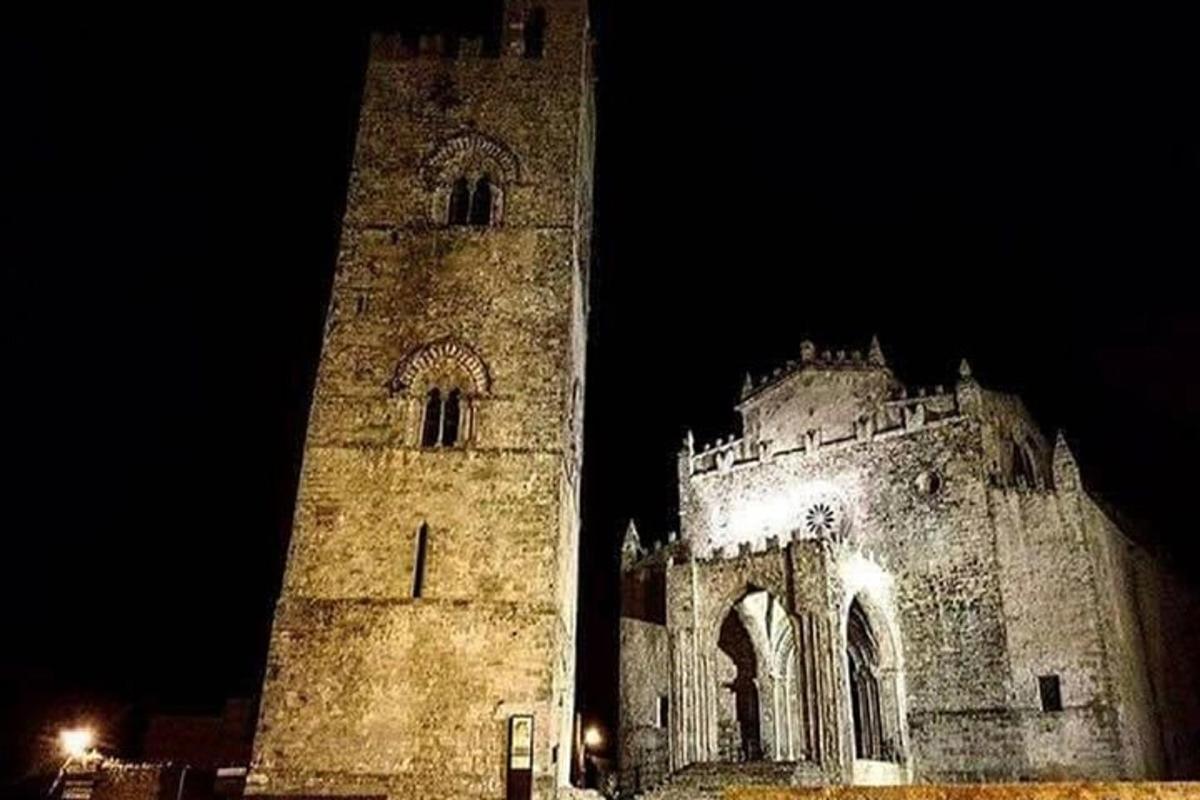 a large stone building with a tower at night