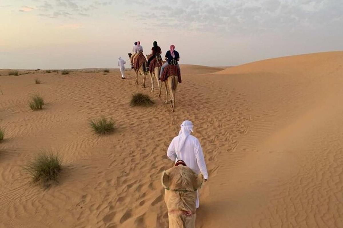 un grup de persones muntant a cavall al desert