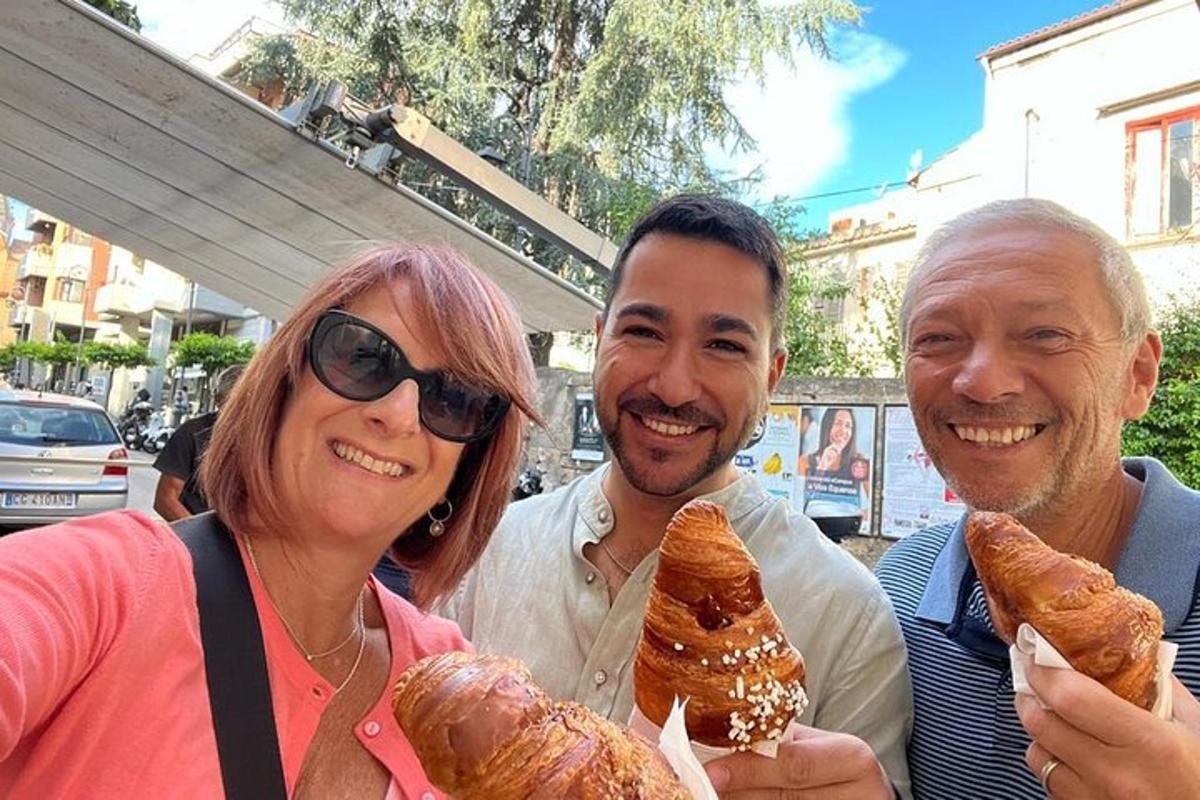 three people posing for a picture holding food