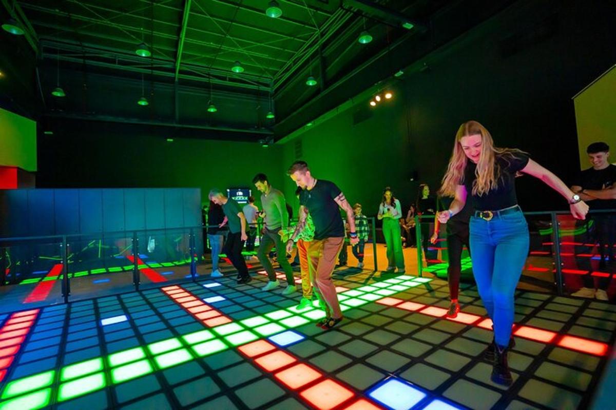 a group of people dancing in a room with lights