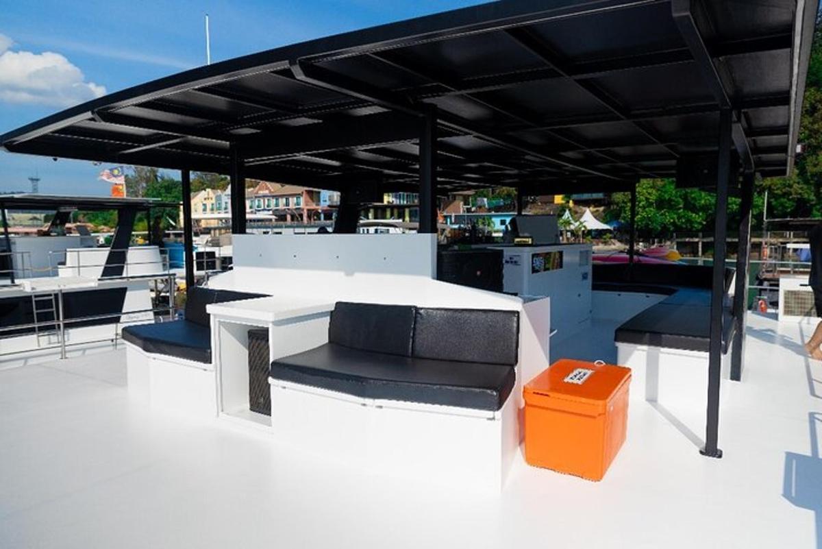 un patio con tavolo, panche e una tettoia nera