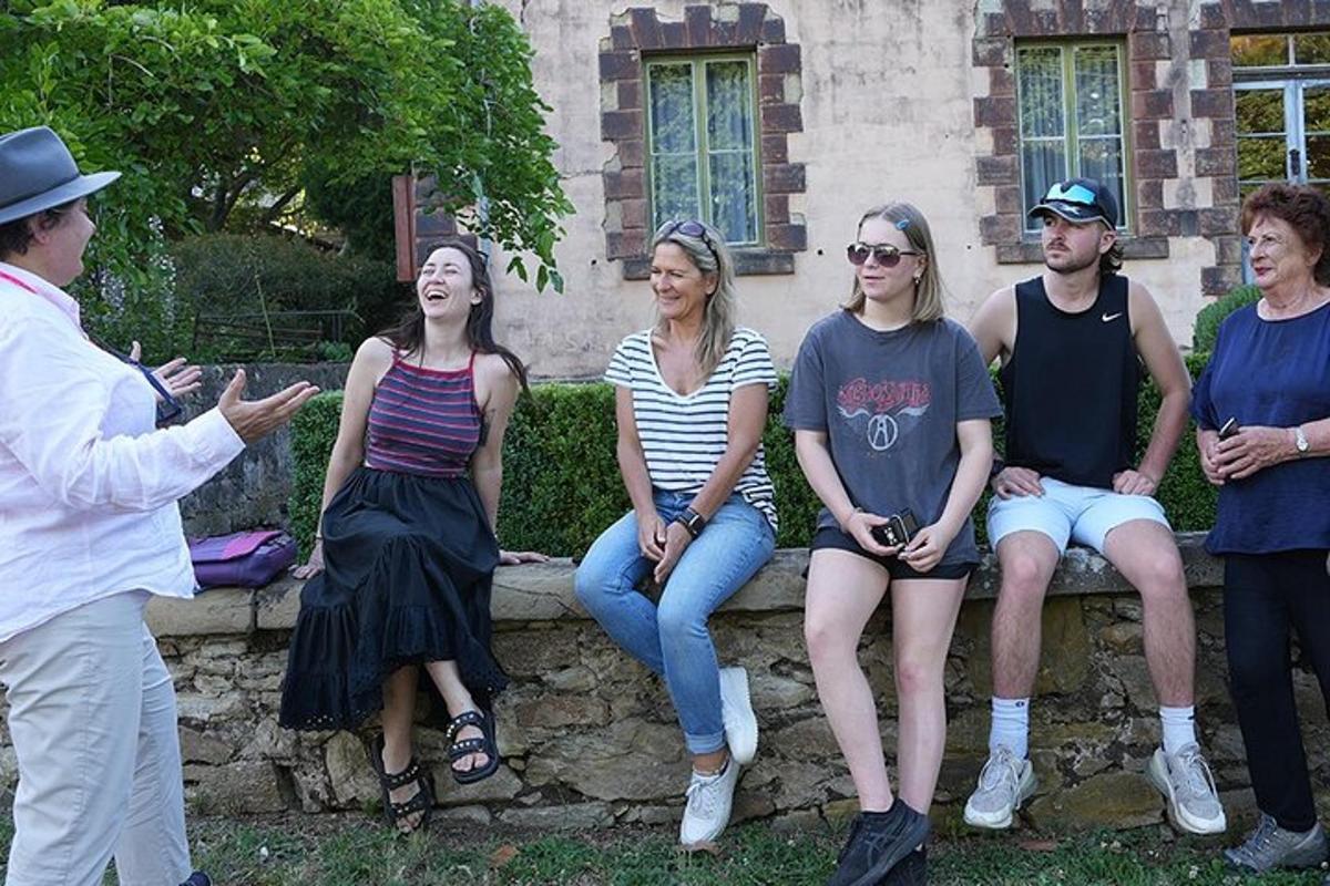 a group of people sitting on a stone bench