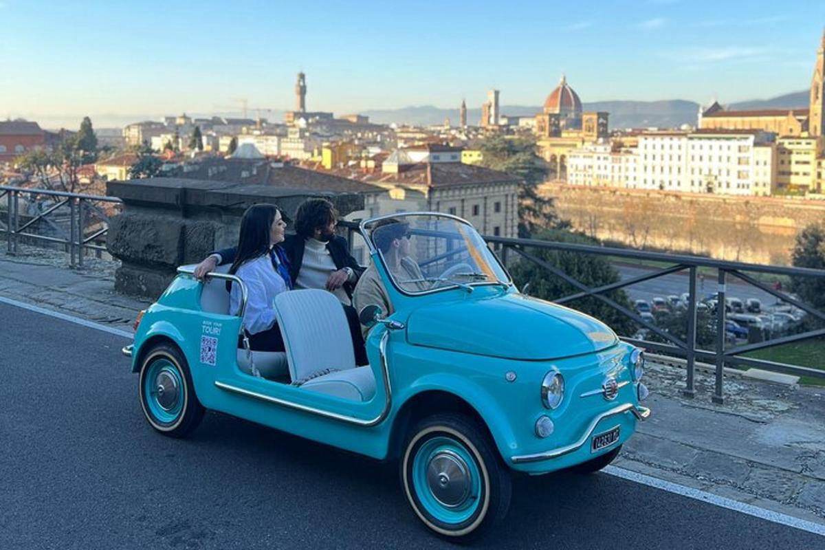 two people are riding in a blue car