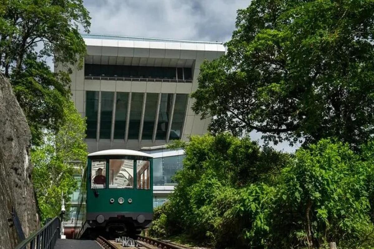 Ένα πράσινο τρένο στις γραμμές μπροστά από ένα κτίριο