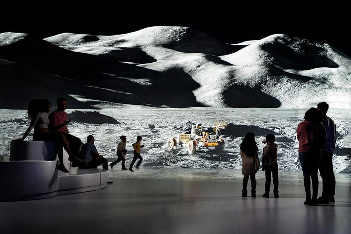 a group of people looking at a display of a glacier